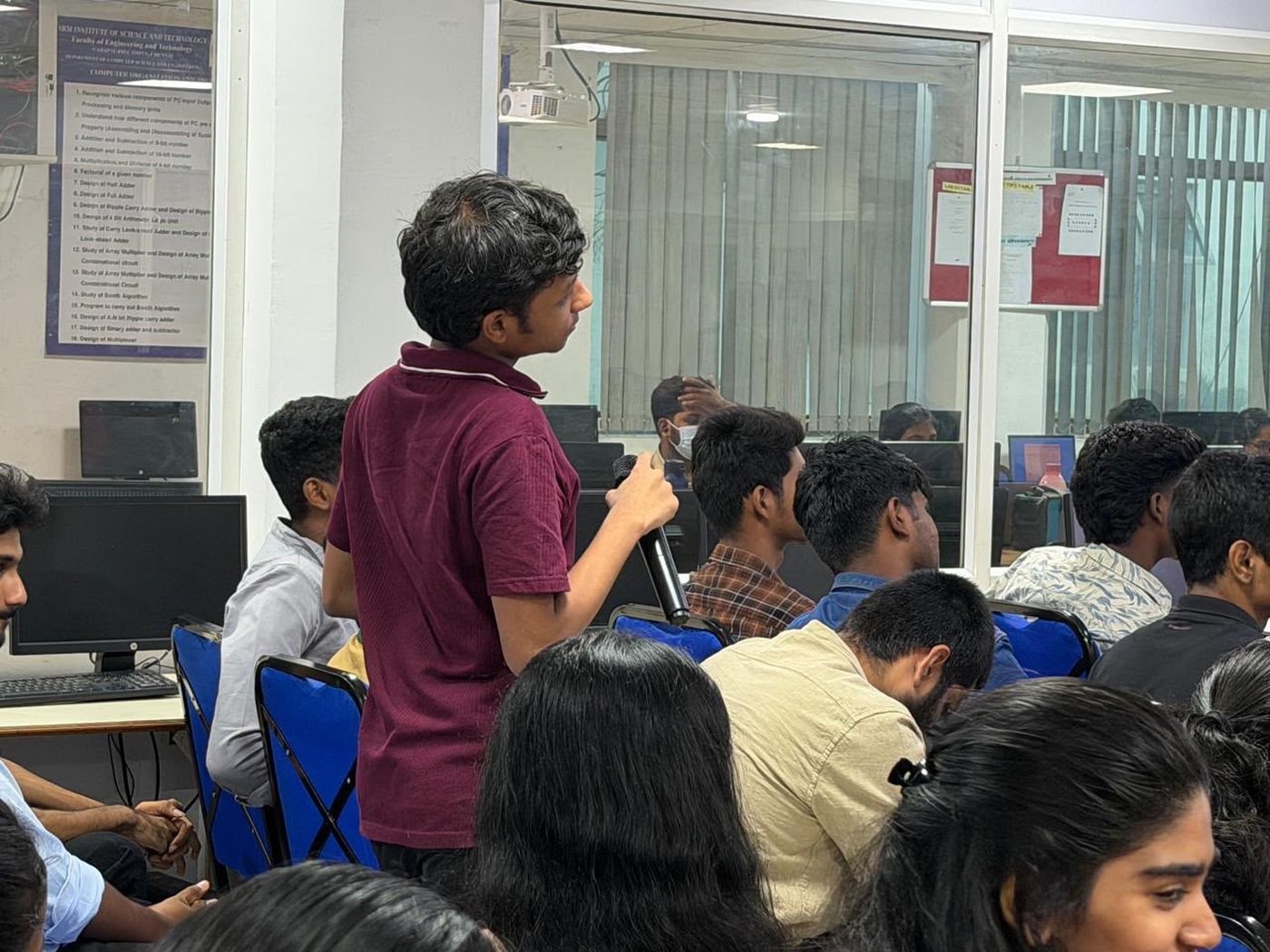 A first-year student putting a question to the speaker