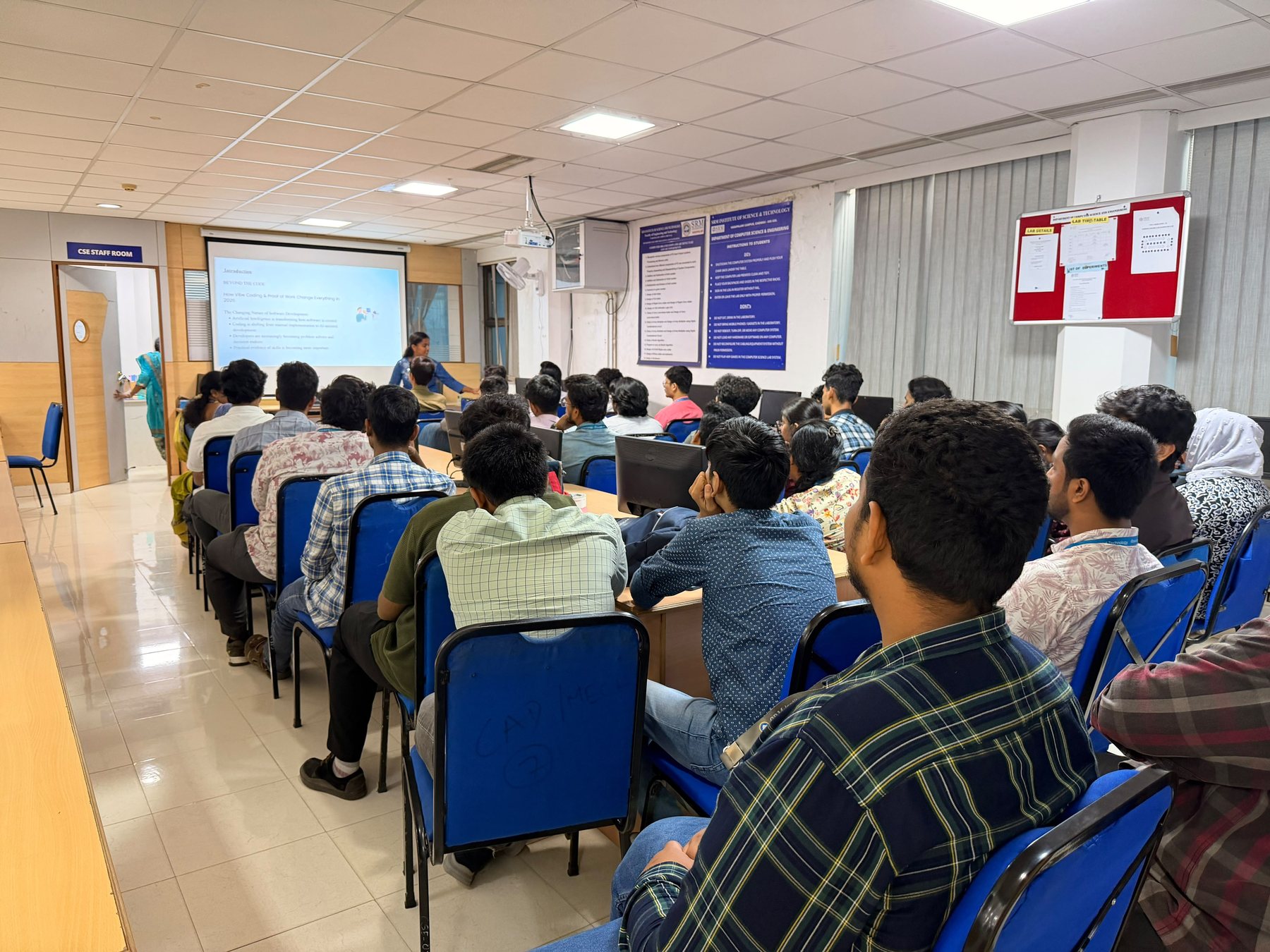 A speaker presenting to a full lab during a CSI session
